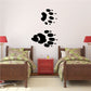 Black raccoon track wall decal with paw print trail