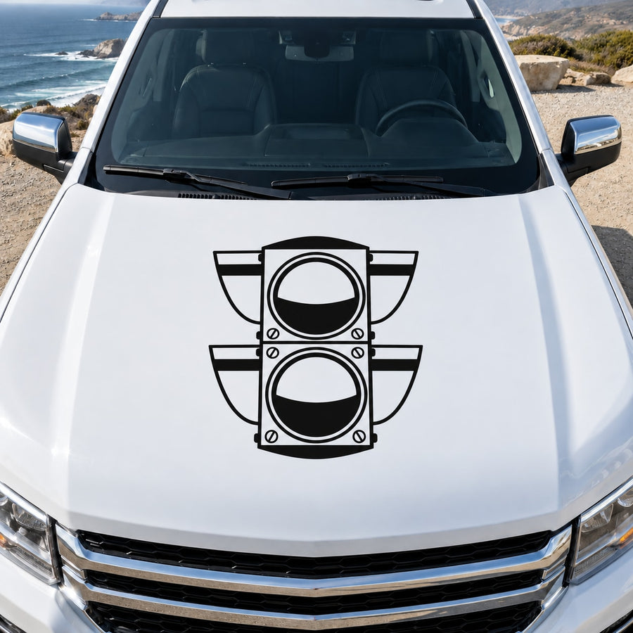 Light vinyl decal on car hood with two stacked circular icons and wing accents