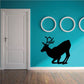 Kneeling reindeer wall decal with black silhouette and decorative rings