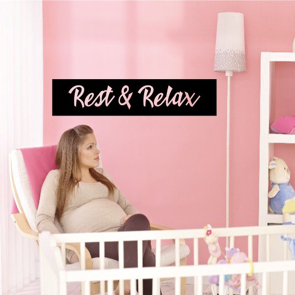 Rest & Relax wall decal with white cursive lettering on a black rectangle