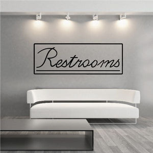 Restrooms wall decal with black script text in outlined rectangle