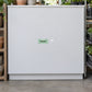 Super Sale New Product 100% Best Quality Retail Discount Sign Sticker applied in A blank smooth matte white display cabinet front at a garden seed store, plant pots and seed trays only extreme sides.