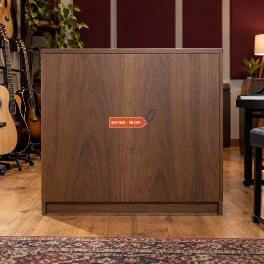 New Price 29.99 Retail Discount Sign Sticker displayed on a musical-instrument shop display cabinet