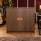 New Price 29.99 Retail Discount Sign Sticker displayed on a musical-instrument shop display cabinet