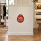 50% Buy Now Retail Discount Sign Sticker displayed on a clothing boutique display cabinet