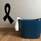 Black awareness ribbon decal on light wall