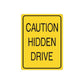 Yellow road sign decal: "CAUTION HIDDEN DRIVE" in black
