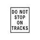 Road sign wall decal featuring black text “DO NOT STOP ON TRACKS”