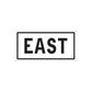 Vinyl road sign decal with EAST lettering in black on a white sign