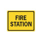 Fire station road sign vinyl sticker, yellow with black border and "FIRE STATION" text