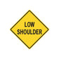 Yellow road sign sticker: 'LOW SHOULDER' in a diamond