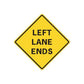 Yellow road sign sticker with black border reading "LEFT LANE ENDS"