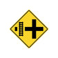 Road sign sticker, yellow diamond with black arrow-cross and barrier
