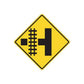 Road sign sticker: yellow diamond with black cross and dashed lane markings