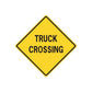 Yellow diamond road sign sticker with black border and text “TRUCK CROSSING”