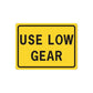 Road sign wall decal with yellow face and black “USE LOW GEAR” lettering