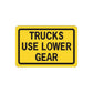 Road sign vinyl decal sticker with yellow panel and text TRUCKS USE LOWER GEAR