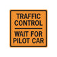 Orange traffic control wall decal with black border and text: TRAFFIC CONTROL, WAIT FOR PILOT CAR.
