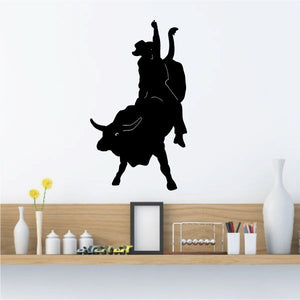 Rodeo bull riding wall decal, black silhouette of rider on bucking bull