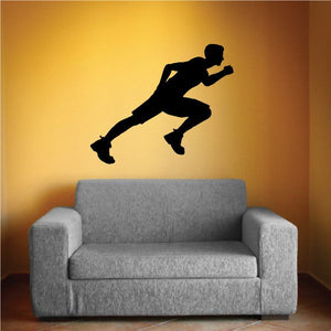 Black running runner wall decal silhouette above a sofa