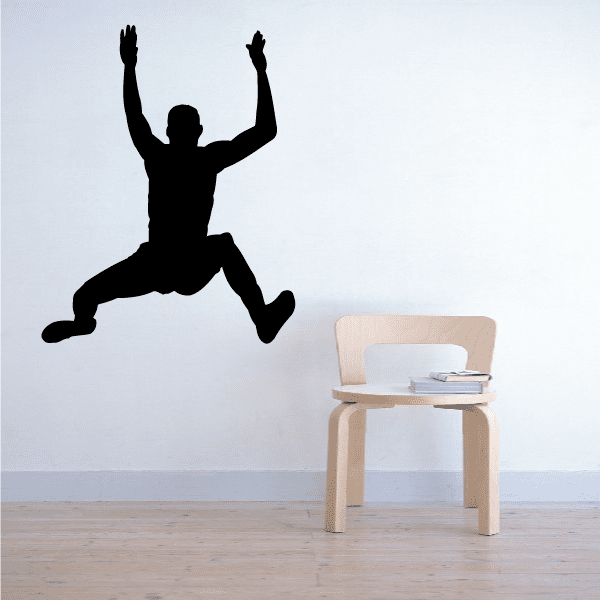 Running wall decal of a black basketball player silhouette mid-dunk