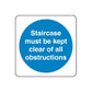 Safety sign decal: blue circle with white text, 'Staircase must be kept clear of all obstructions'
