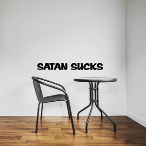 Black text vinyl wall decal reading 'SATAN SUCKS'.