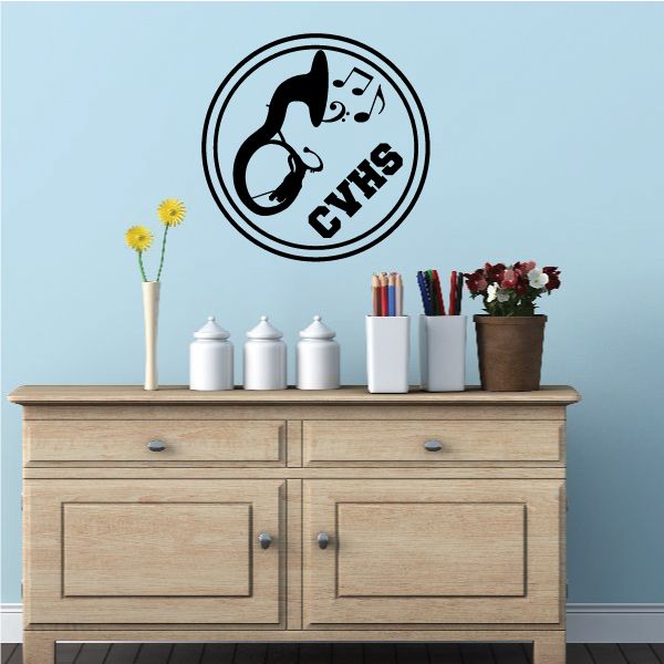 Circular marching band decal with black silhouette holding instrument and music notes