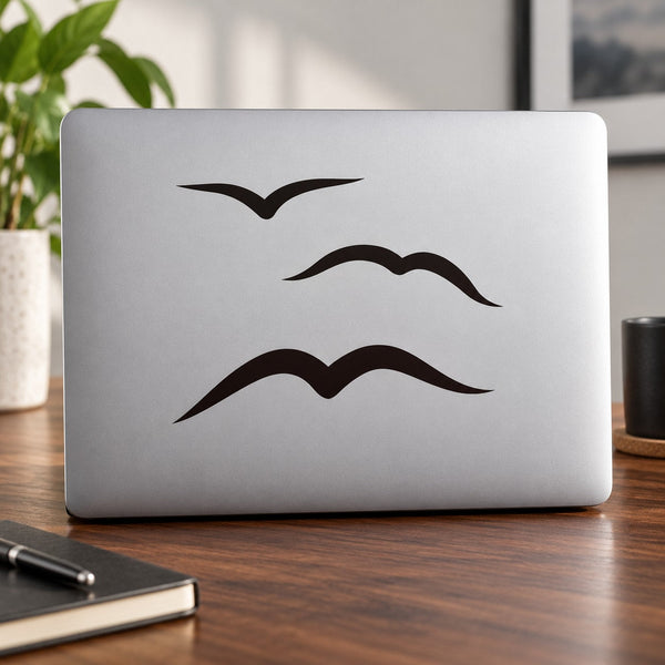 Flying seagulls decal with three black bird silhouettes on laptop lid