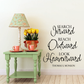 Black calligraphy wall decal with 'Search inward reach outward look heavenward'.