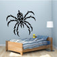 Black thorny spider wall decal with segmented legs and bold web pattern