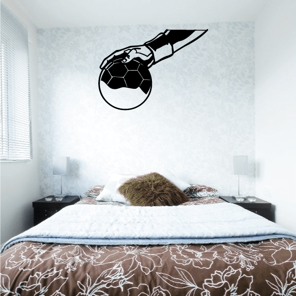 Rugby ball wall decal with black hand silhouette, playful grabbing design