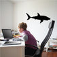 Shark hunting decal with a black shark silhouette on a wall
