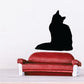 Sitting cat decal with black cat silhouette on red sofa