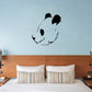 Side face panda decal with black ears and eye patches on a light wall