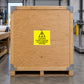 Caution Centre of Gravity sticker on a plywood freight shipping crate