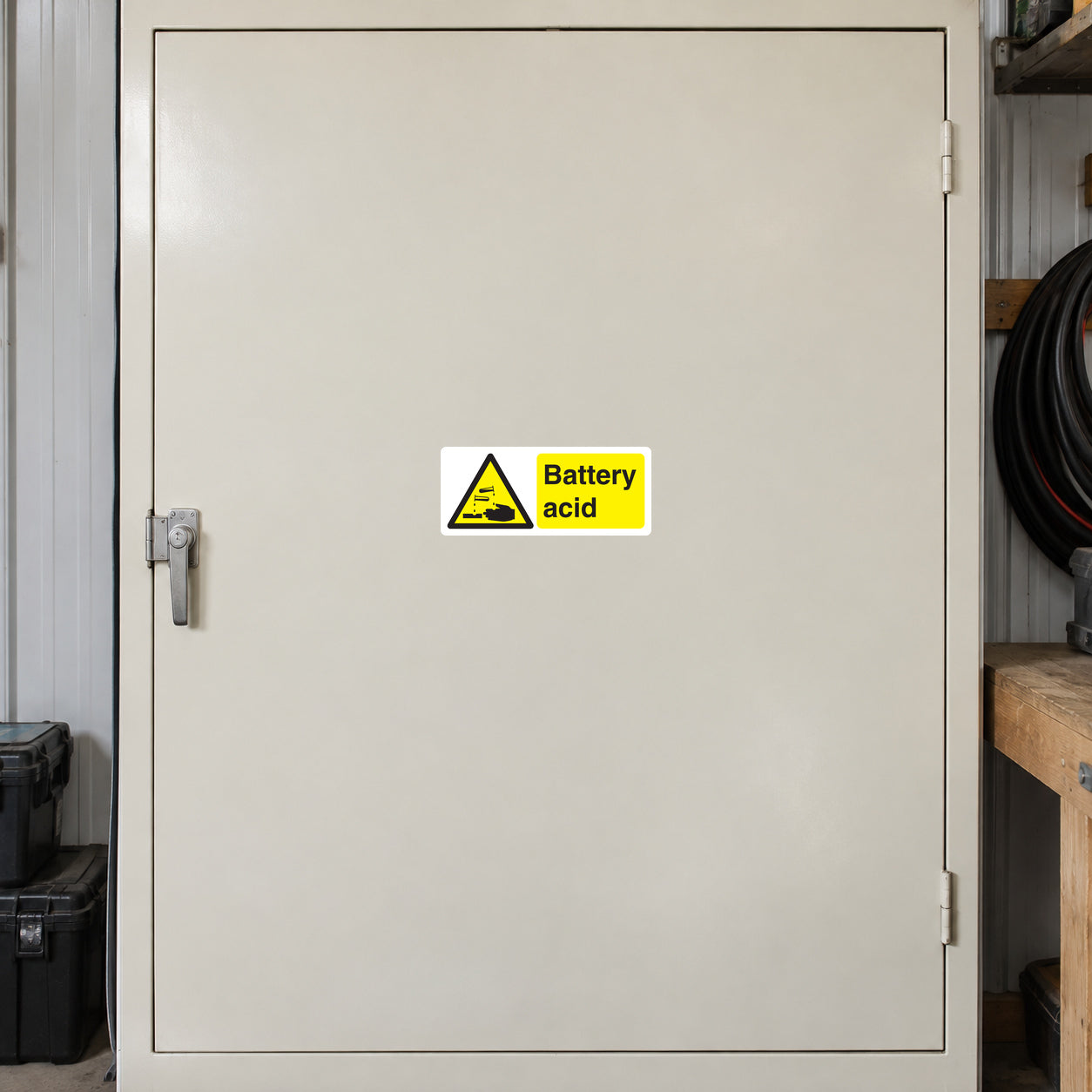 Caution Battery Acid Sticker applied in Closed cream battery maintenance cupboard in an independent marine workshop, broad seamless frontal door central, latch far left, glimpse of coiled marine cable and timber workbench at extreme right.