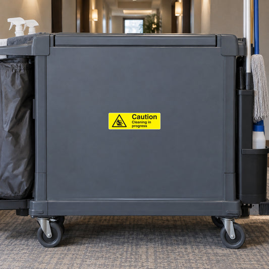 Yellow caution sticker with black warning text: Cleaning in progress