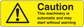 Yellow caution sticker with black warning triangle and Caution text, automatic notice