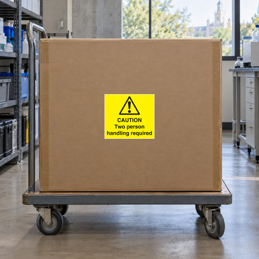 Caution two person handling required sticker on yellow warning label