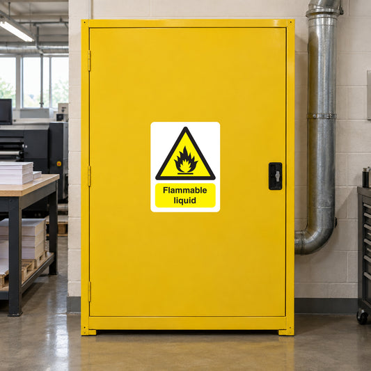 Flammable liquid warning sticker with flame icon and text on a yellow door