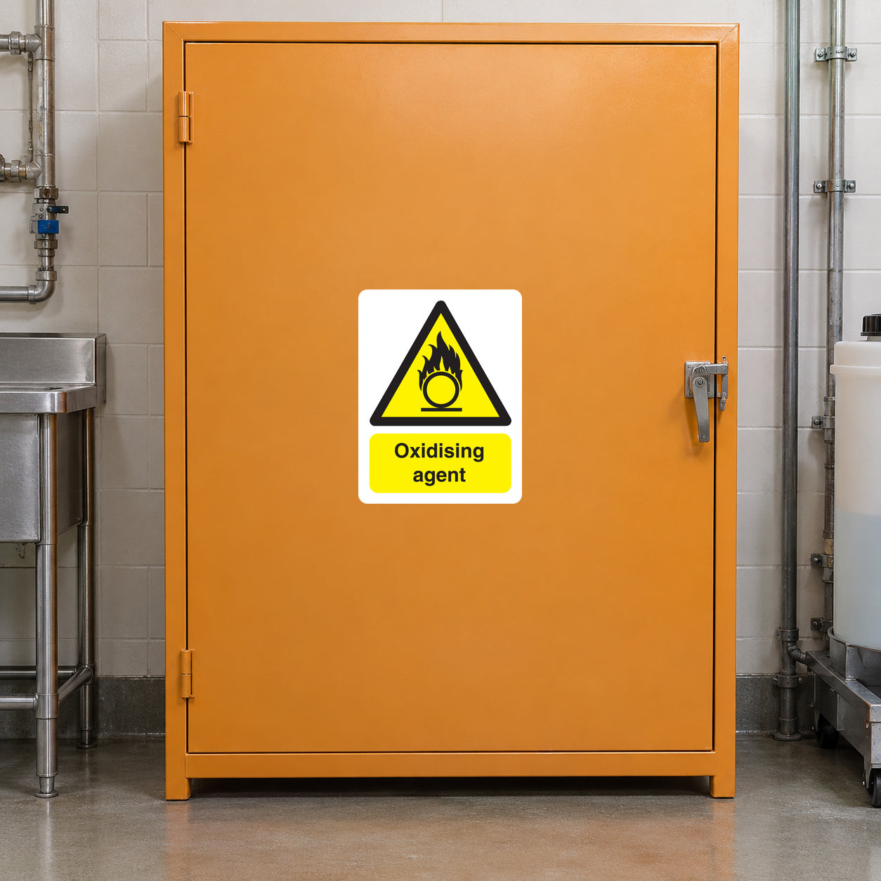 Warning sticker for oxidising agent on orange metal door with triangular hazard symbol