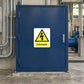 Switchgear caution sticker on blue metal cabinet door with warning symbol
