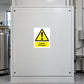 Caution Liquid Nitrogen Sticker applied in Flat broad white side panel of a closed cryogenic storage equipment enclosure in a biomedical laboratory, one uninterrupted face central, stainless dewar and pipework only at far edges, no frost cloud or people.