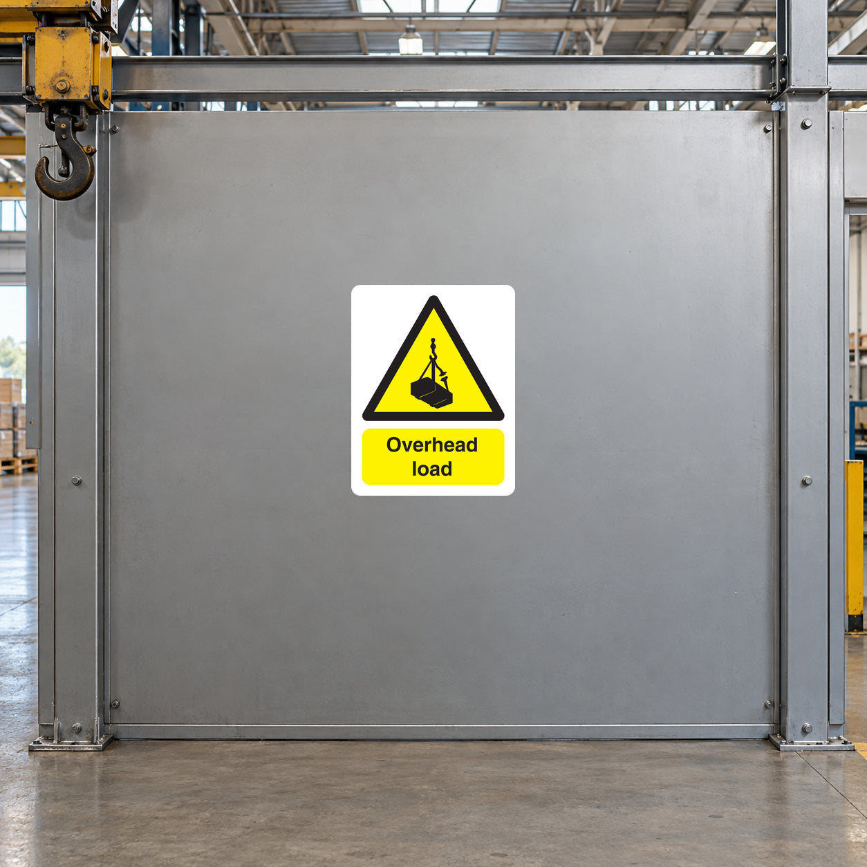 Overhead load caution sticker with yellow warning triangle and “Overhead load” text