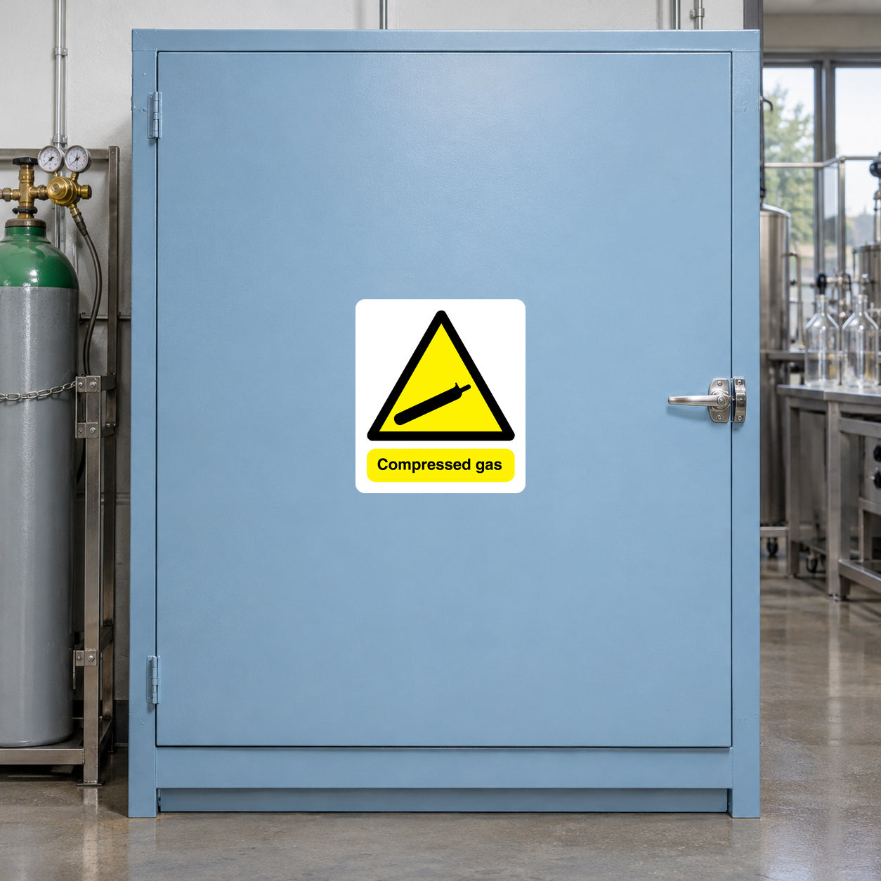 Compressed Gas Sign Rectangle Sticker applied in Closed pale blue compressed-gas cabinet in a beverage laboratory, broad single smooth central door, latch far right, secured cylinder visible only beyond far left.