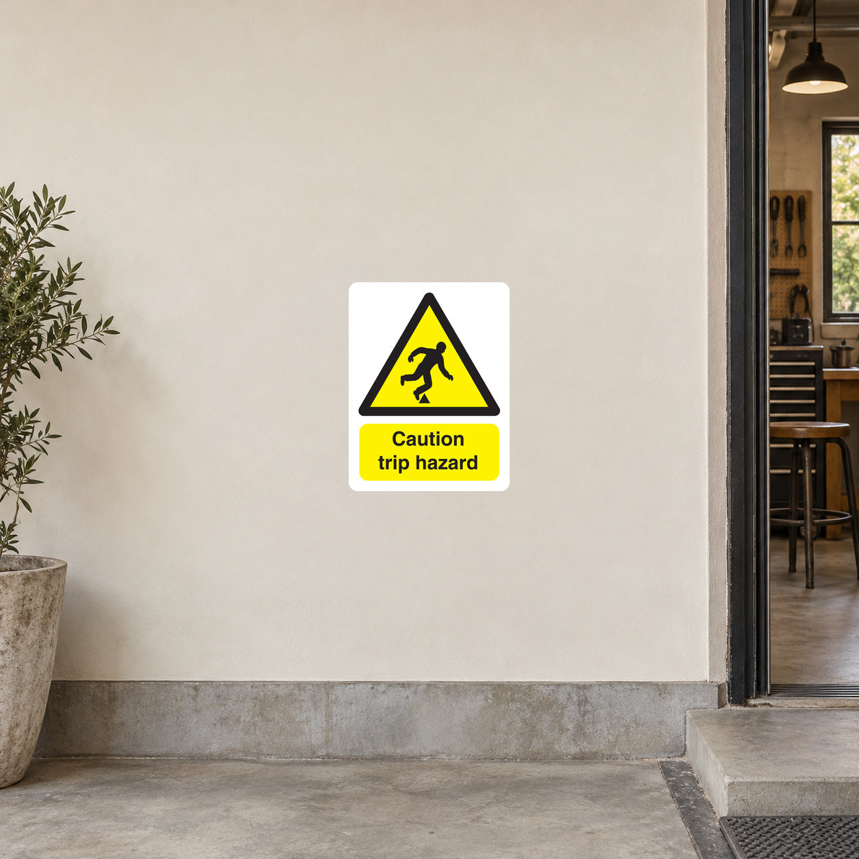 Trip hazard warning sticker, yellow caution triangle with falling figure and “Caution trip hazard” text