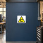 Yellow triangular caution symbol sticker on a workshop service panel