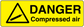 Danger compressed air warning sticker with yellow hazard triangle and DANGER text