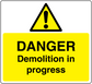 Yellow warning sticker with black danger triangle and “Danger Demolition in progress”
